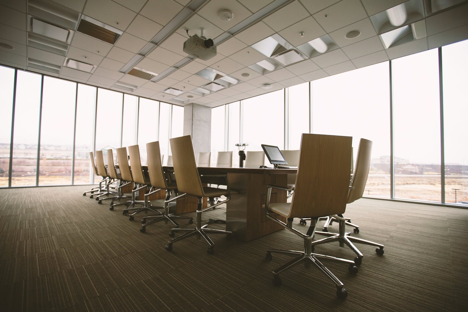 Meeting room with a long table and tall windows