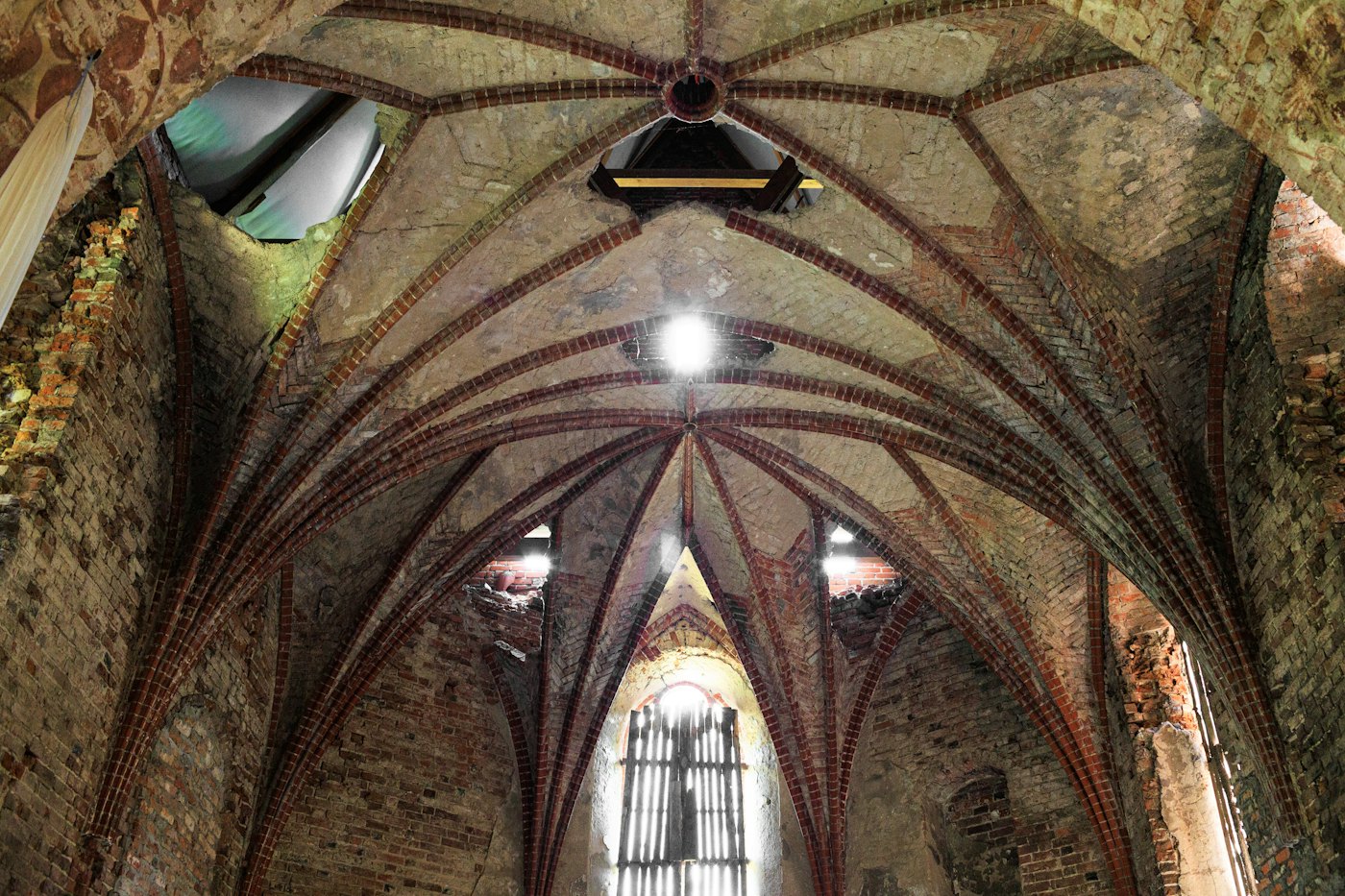 Vaulted brick interior in warm light