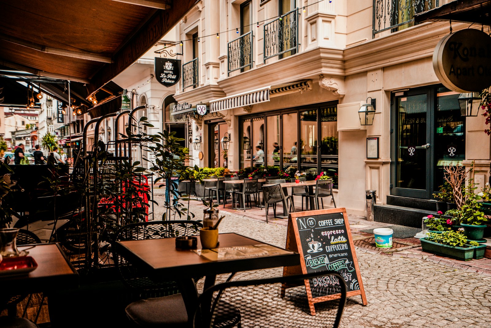 Street with historic façades and café terraces
